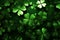 Saint patricks day Background. Green metalic four leaf clover on green surface. Copy space