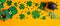 Saint Patricks Day frame border of shamrock four leaf clovers, Irish elf hat, pot of gold, party glasses on orange background.