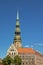 Saint Peter`s church tower above facade of historical buildings, Riga, LAtvia