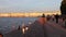 Saint Petersburg, the Arrow of Vasilievsky island, people walk along the embankment of the Neva river, sunset.