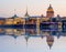 Saint Petersburg cityscape with St. Isaac`s cathedral, Admiralty building and Palace bridge at sunset reflected in Neva river, Rus