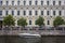 Saint Petersburg/ Russia - 26.06.2019: Large modern white gray pleasure boat parked in a river in the city against a historic