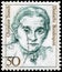 Saint Petersburg, Russia - April 21, 2020: Postage stamp issued in the Germany with a portrait of the Christine Teusch, 1888-1968