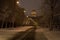 Saint Petersburg, Russia in darkness of winter early morning. St. Isaac Cathedral, an empty snowy street and bare trees