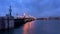 Saint-Petersburg. Russia. Petersburg evening. Trinity Bridge with evening lights is reflected in the Neva River.