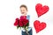 Saint Valentine`s day. Handsome gentleman boy with blue vest, red tie, red roses bucket and red balloons . Valentines day kids. L