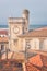 Saintes-Maries-de-la-Mer, top view of town tiled roofs, building of ancient Town Hall and seaside, Camargue, France