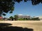 Saitama / Japan - 08/12/20: An empty schoolyard with playground equipment and buildings on a sunny day.