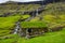 Saksun typical Faroe Islands house under the waterfall