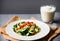 Salad with arabic couscous and vegetables on a white plate