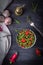 Salad with arugula, strawberries, garlic and cheese roquefort on a wooden background. Low key. Top view