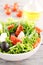 Salad with arugula, tomatoes, black olives, lettuce with mozzare