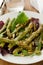 Salad asparagus and pine nuts in white plate