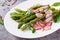 Salad from asparagus with radish and chard. Vegan cuisine.