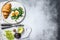 Salad with avacado, arugula, croissant and egg. Gray background. Top view. Space for text