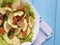Salad with avocado gourmet red fish vegetable dinner on blue wooden lemon