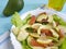 Salad with avocado red fish vegetable dinner on blue wooden lemon