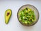 Salad with avocado and sesame seeds, oil is poured, on a wooden. Avocado salad in a plate, vegetarian food, green dietary salad