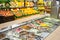 Salad bar on the background of shelves with vegetables and fruits in supermarket