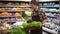 Salad bar with organic vegetables and greens in supermarket. Male shop employee arranging fresh greens on a bar in local