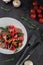 Salad with boiled beef tongue, mushrooms, tomatoes and spinach on grey table. Traditional dish menu served in a restaurant, top