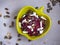 Salad of boiled beets and sunflower seeds and pumpkin and feta cheese in a yellow ceramic salad bowl, seasoned with vegetable oil