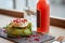 Salad, bottle of drink and glass on cafe table