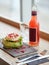 Salad, bottle of drink, glass and cutlery on table