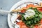 Salad with burrata cheese, green pesto, arugula salad and tomatoes on plate. banner, menu, recipe place for text, top view
