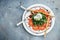 Salad with burrata cheese, green pesto, arugula salad and tomatoes on plate. banner, menu, recipe place for text, top view