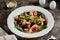 Salad with canned tuna, pasta, cherry tomatoes, olives, parmesan, olive oil and basil.