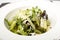 Salad of carambola, pear, grapes, salad mix, brie cheese