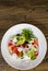 Salad with cheese, cabbage, pepper, tomato and cucumber on wooden table. with copy space. top view