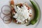 Salad with cheese, onion rings and green pepper on a white plate.