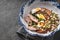 Salad with chicken, pumpkin, beans and quail eggs in a ceramic bowl