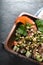 Salad with chicken, pumpkin, beans in a wooden bowl