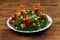 Salad Christmas wreath on wooden table