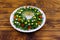 Salad Christmas wreath on wooden table