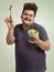 The salad dance. Studio shot of an overweight man holding a bowl of salad in a silly pose.