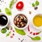 Salad dressings in white bowls with spices, olives and wild herbs