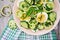 Salad of eggs and cucumbers with green onions and basil.