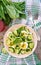 Salad of eggs and cucumbers with green onions and basil.