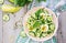 Salad of eggs and cucumbers with green onions and basil.