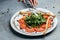 Salad of fresh arugula, tomatoes and soft Italian cheese burrata with green pesto. banner, menu, recipe place for text, top view