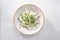 Salad fresh cucumbers and radish with sour cream and onion isolated on white background