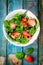 Salad with fresh spinach and strawberries with balsamic sauce and sesame