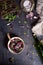 Salad with fresh summer greens and herbs on rustic wooden table. View from above, free text space.