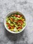 Salad with fresh vegetables and canned mussels on a grey background, top view. Delicious healthy diet food.Snack, tapas