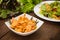 Salad with fried shrimps. Wooden background. Top view. Close-up