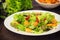 Salad with fried shrimps. Wooden background. Top view. Close-up